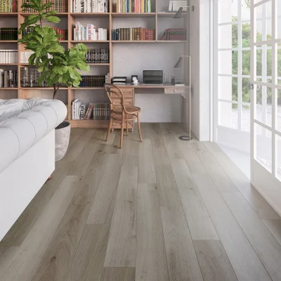 Bright home study with a wooden bookshelf wall, desk and chair with laptop, floor lamp, a potted plant, and large glass doors opening to greenery.