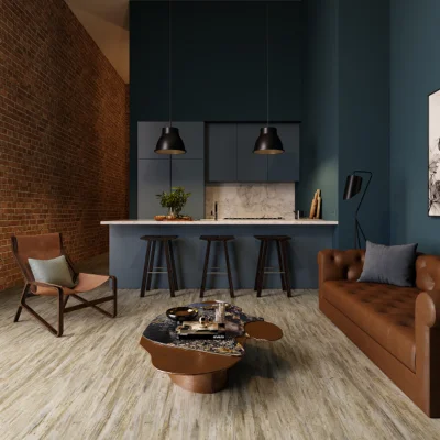 Open-plan living space with a marble kitchen island, three bar stools, teal walls, brick accent wall, brown leather sofa and a wooden armchair.